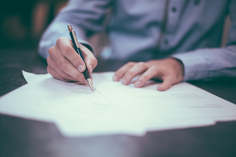 A professional writing on a printed document with a pen
